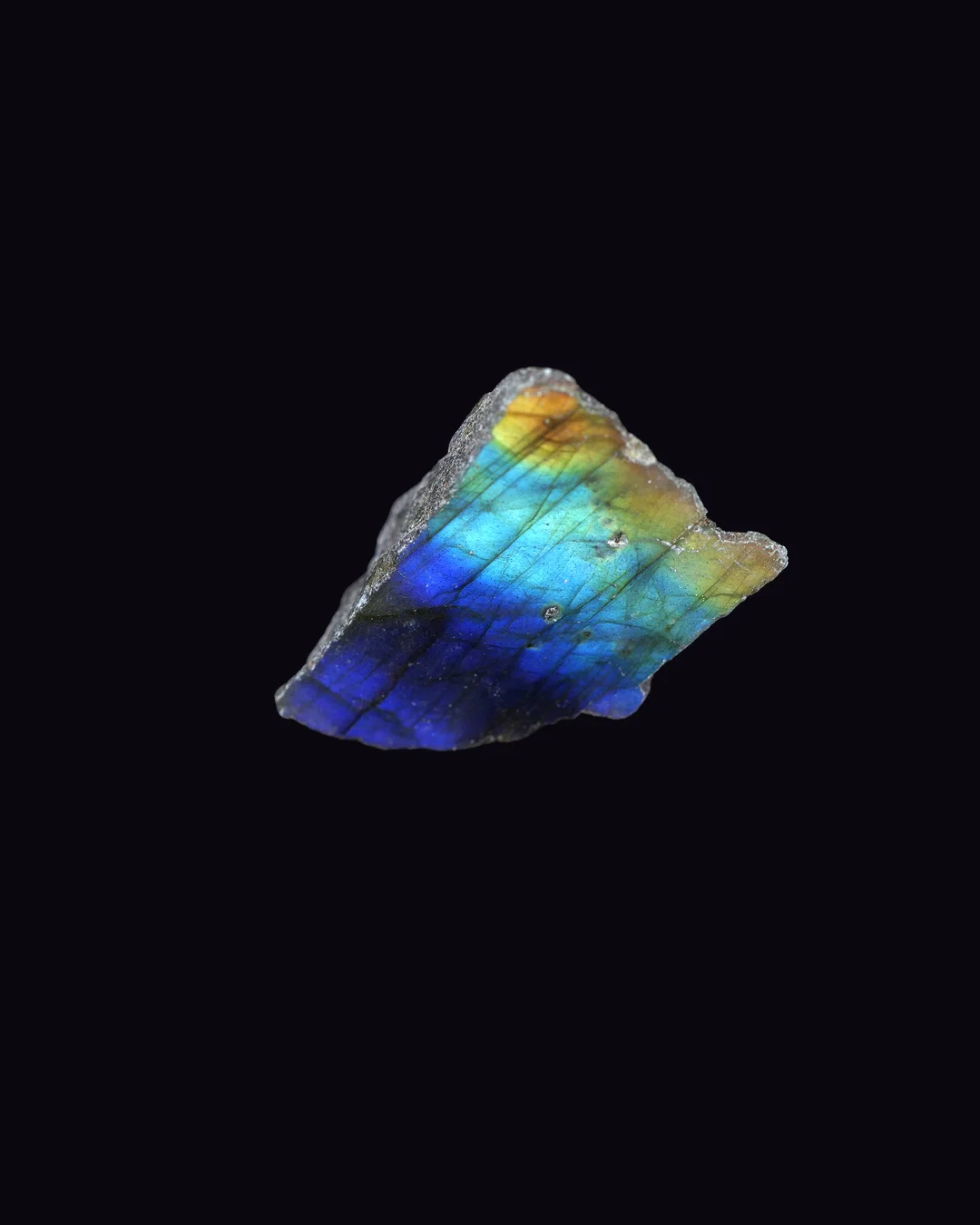 Labradorite, grey body with blue, green, gold, orange flash and smoky grey feldspar mineral specimen