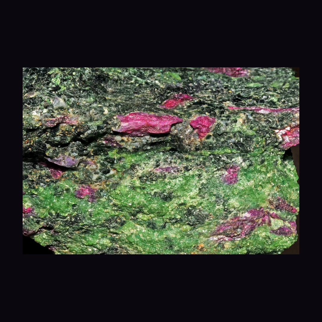 Ruby in Zoisite, chrome green with opaque pink-red patches and black flecks rock (aggregate) mineral specimen